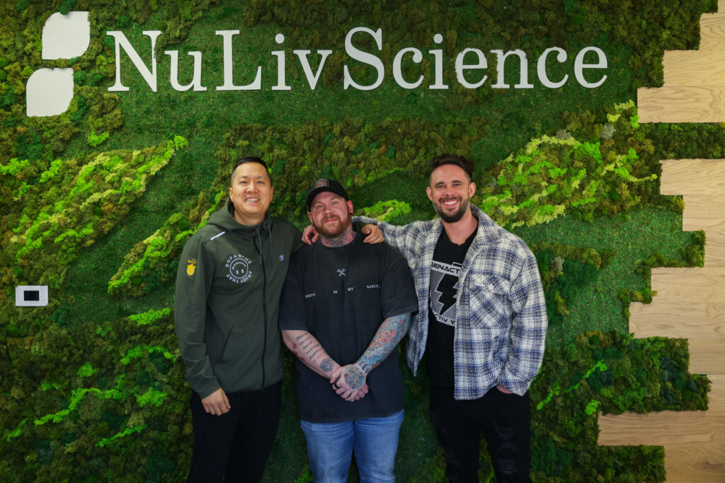 Group photo at NuLiv Science headquarters featuring podcast hosts and team. Represents industry collaboration and supplement brand partnerships.