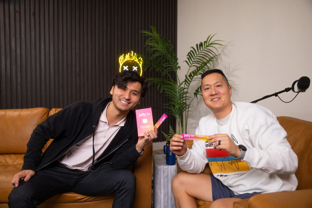 Jelly IV founder and NuLiv founder posing for a photo in a podcast studio with Jelly IV products.